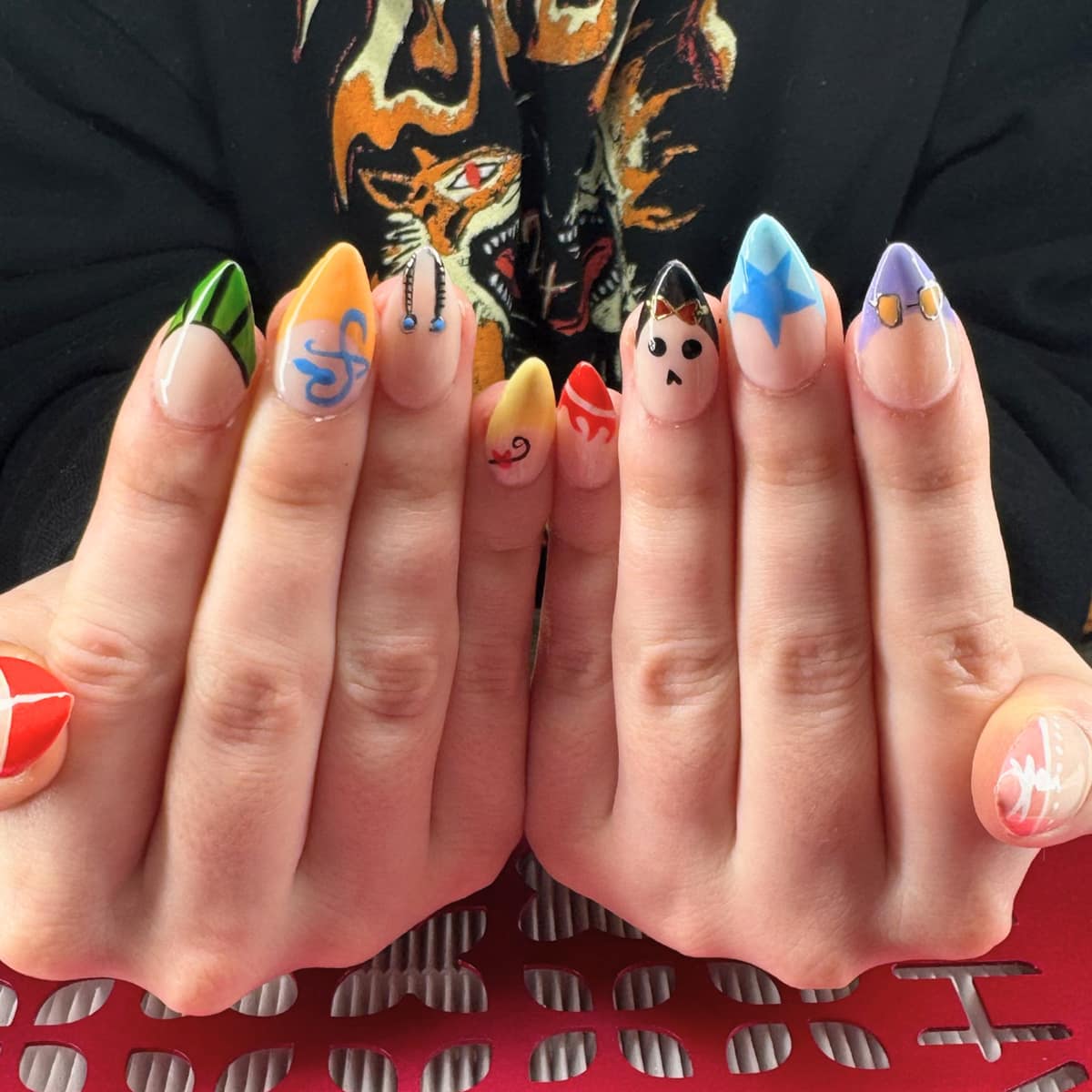 Short round set of hand-painted characters and doodles — a different design on every nail.