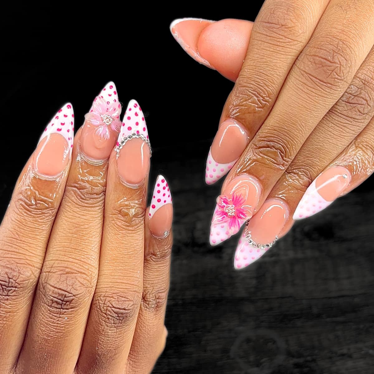 Stiletto set with pink polka-dot french tips, crystal cuff details, and a hand-sculpted flower.